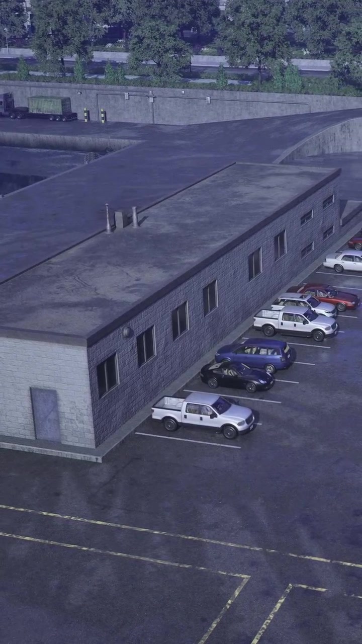 Bygning med parkerede biler nær et lagerområde i et bymiljø