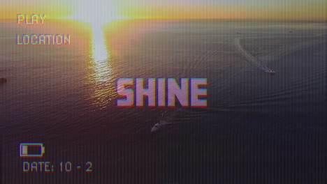 animation of shine text on video camera screen with digital interface filming sun and sea landscape