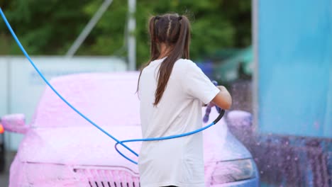 woman washing car at self-service car wash