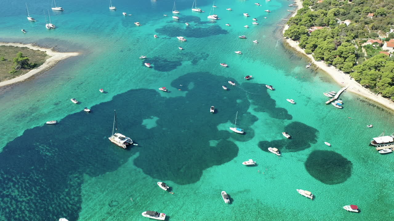 Blue Lagoon With Yachts, Boat, And Catamaran Anchored In Blue Sea Near Drvenik Veli Island In Croatia. - aerial
