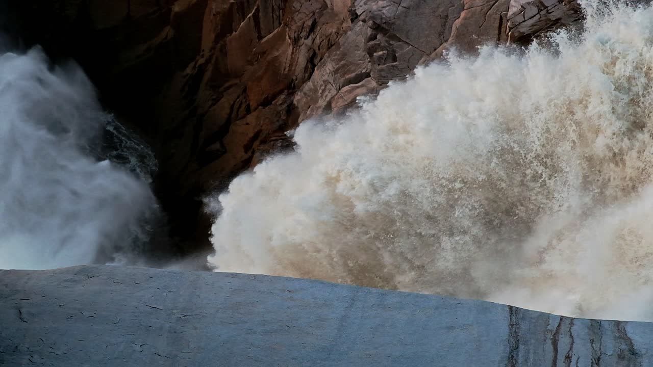 Tons of water thunders down the Augrabis waterfall in the Northern Cape of South Africa