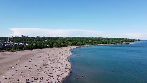 flying over busy toronto beach on lake ontario