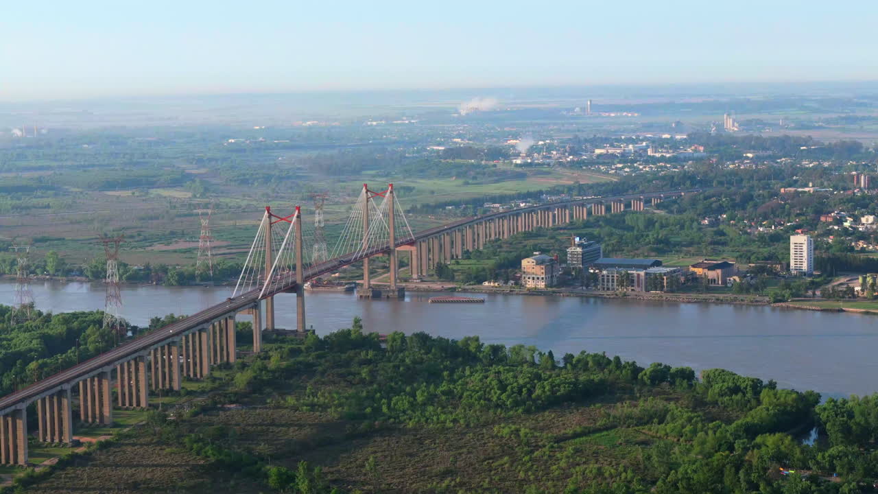 Aerial view of Zárate Brazo Largo Bridge over Paraná River with industrial zone in background, Argentina