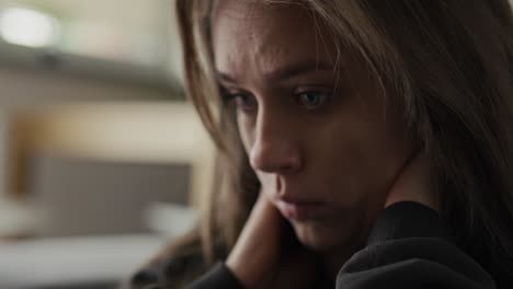 caucasian nervous woman rubbing the nails and sitting at home.