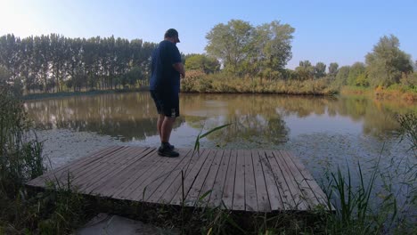 Adult-Male-Successfully-Skimming-Rocks-At-Hanshiqiao-Wetlands,-Beijing,-China