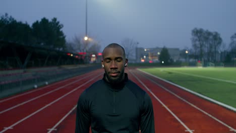 man on a track at night