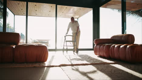 older man using walker in modern living room