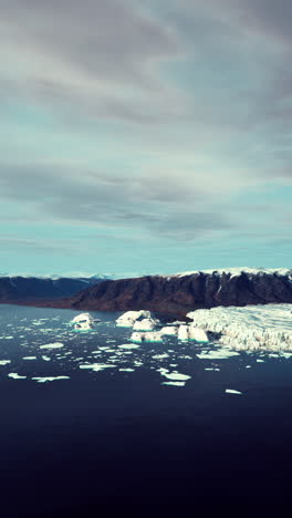 stunning aerial view of icebergs and glacier in arctic ocean