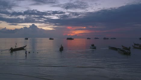 beautiful sunset on a beach with boats