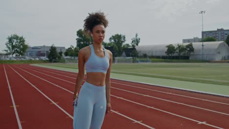 woman stretching on running track