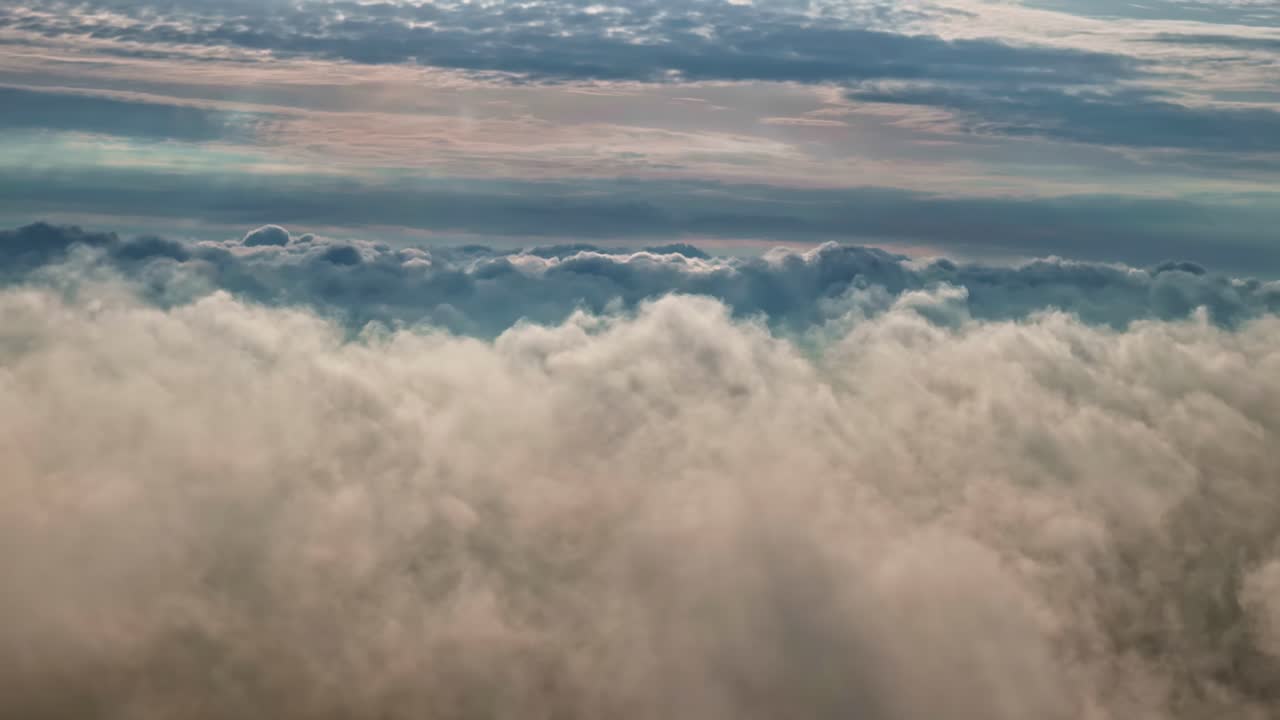 Drone footage of thick clouds gathering in a blue sky