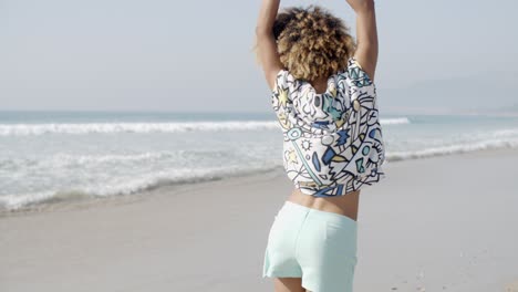 girl jumping with joy on the seashore