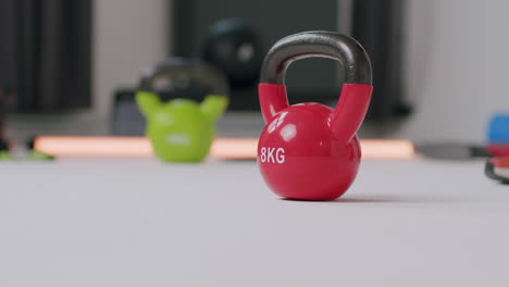 taking the dumbbells from the floor of a gym - a close-up shot