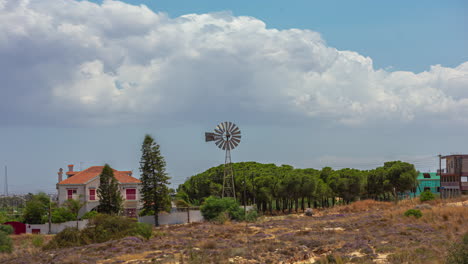 time lapse of clouds and weather vane above scenic countryside outskirts of town