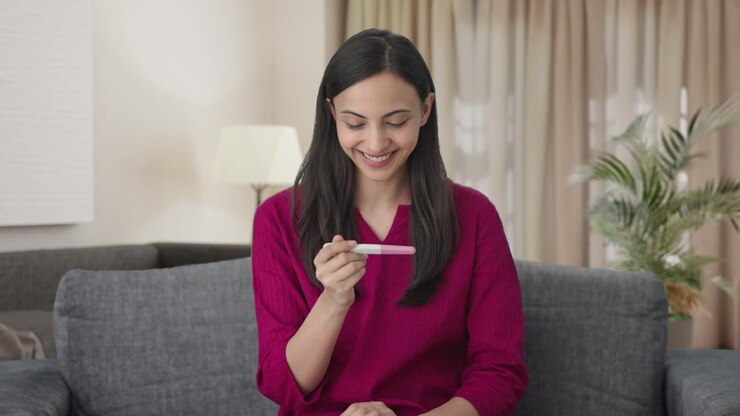 Happy Indian woman checking pregnancy test