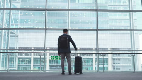 corporate man, back and window at airport