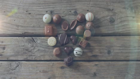 Animación-De-Puntos-De-Luz-Sobre-Chocolate-Sobre-Mesa-De-Madera