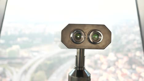 coin-operated binoculars looking out over city buildings