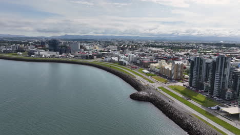 drone shot of reykjavik, iceland, coastal traffic, modern residential buildings on waterfront