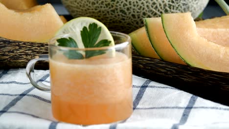 whole and sliced of japanese melons,honey melon or cantaloupe (cucumis melo) glass of melon smoothie healthcare concept.