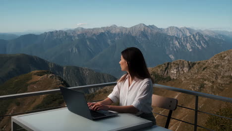 woman working on laptop with stunning mountain view