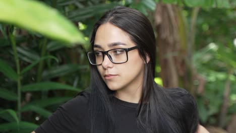 Beautiful-Green-Eyed-Latina-Woman-Sitting-in-Park-Looking-off-to-Side