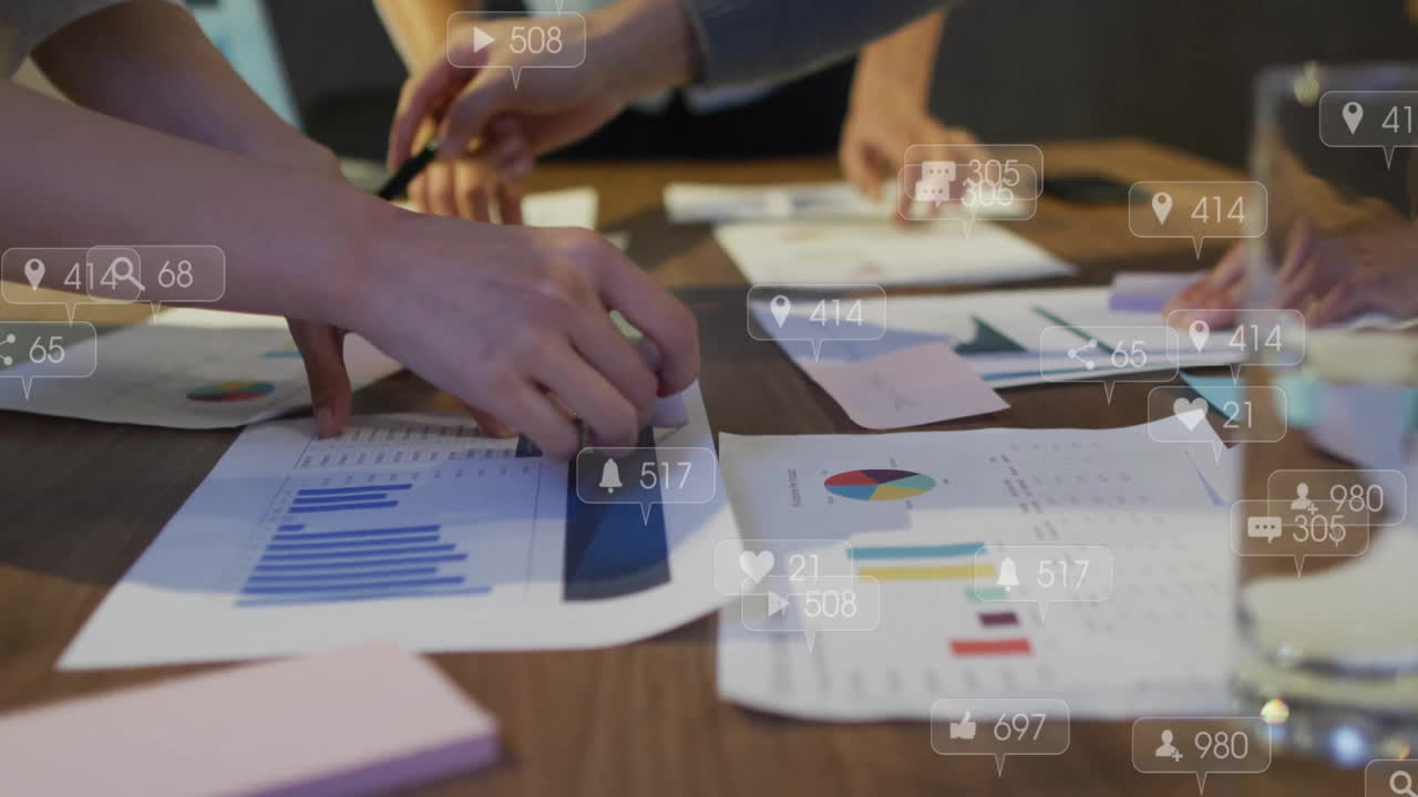 Organizing charts and graphs on table with animation of social media icons