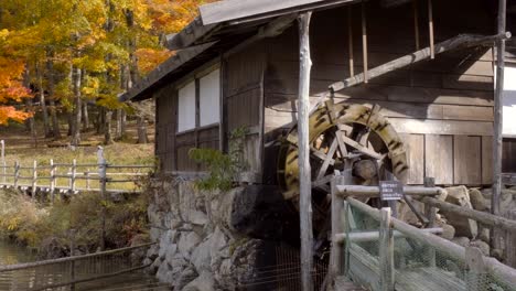 an old traditional japanese house with a water mill