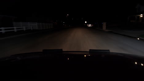 a hood of a car point of view driving at night a dark road headlight show the world