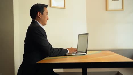 businessman using laptop at table 4k