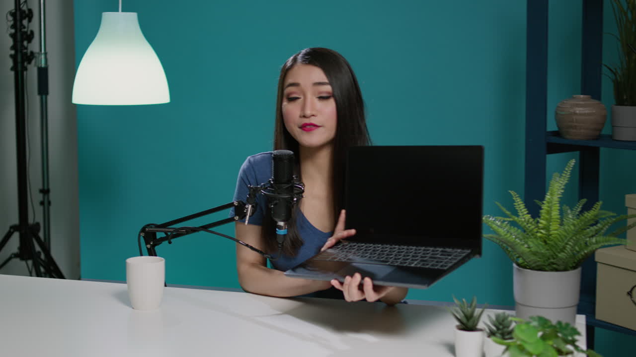 Asian woman reviewing laptop computer on social media podcast