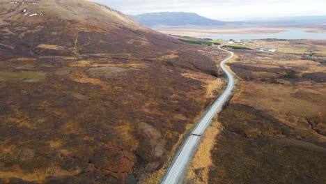 aerial overview of a stunning landscape in rural iceland with a long road running through the countryside