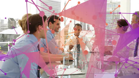 in business meeting, colorful network connections overlaying scene with team discussing