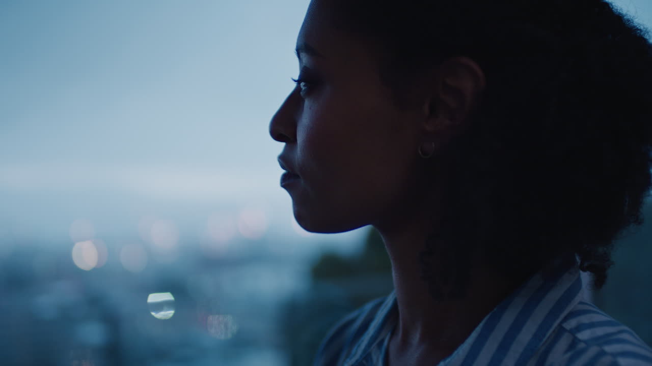 beautiful business woman looking out window in hotel room at sunset planning ahead successful independent female contemplating future enjoying calm evening