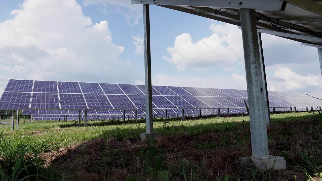 Many rows of solar panels in the green field of a solar power plant. Conservation Ecology Concept