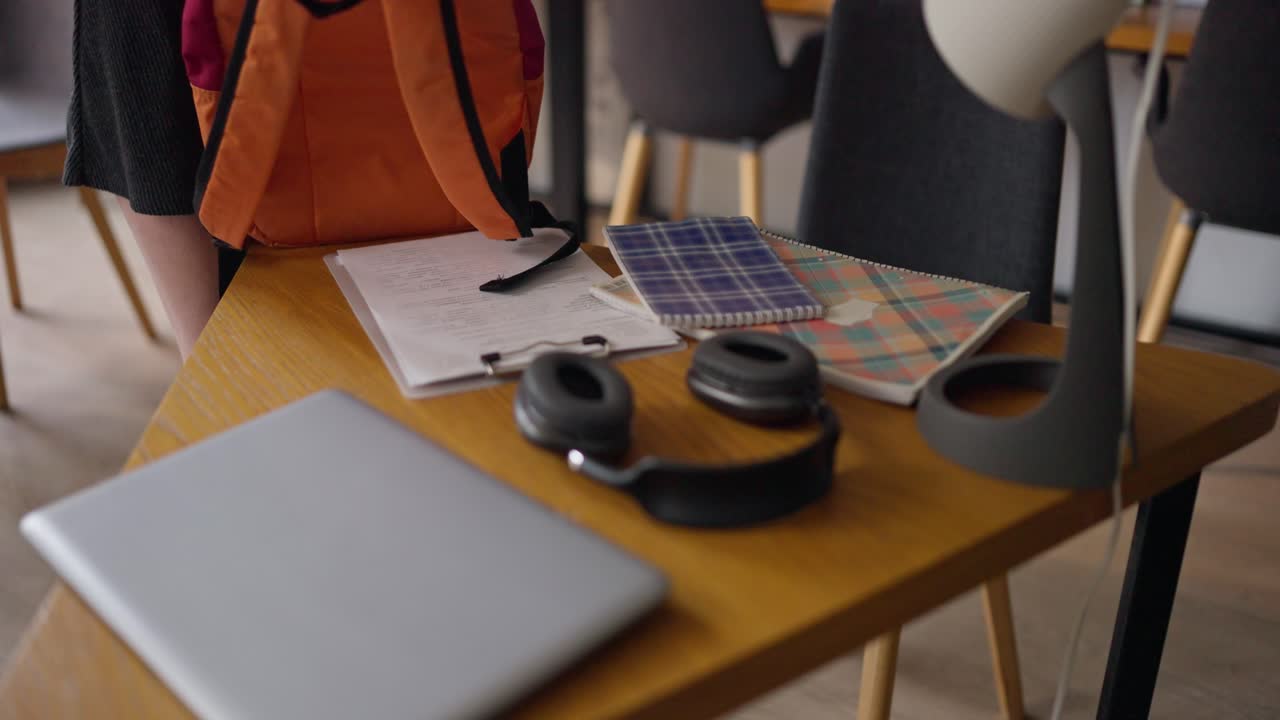 Student Workspace with Backpack, Laptop, and Notebooks