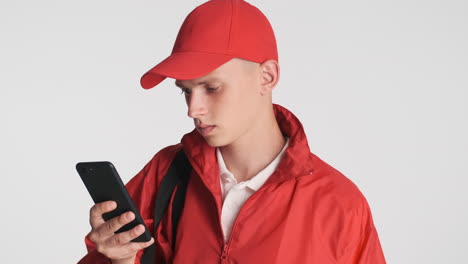 young boy with protective mask checking his phone