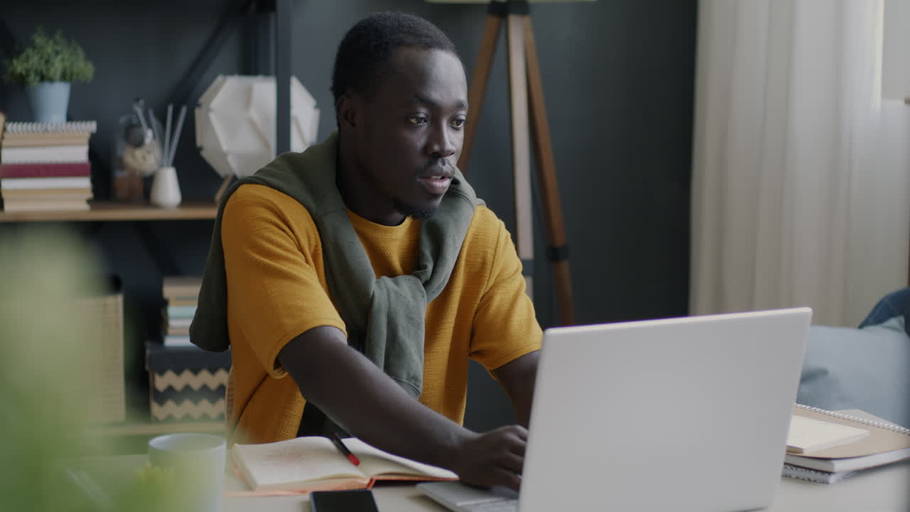 Man Working on Laptop at Home