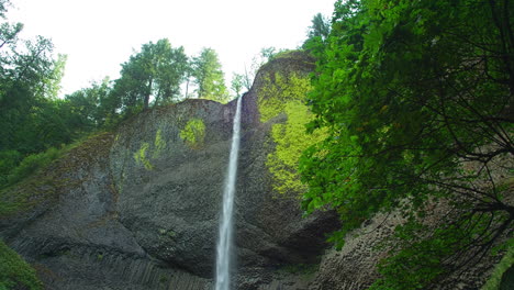 latourell waterfall, creek, basalt columns, foliage, tilt down, slomo