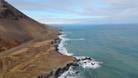 Aerial-Drone-Fly-Iceland-Blue-Skyline-with-Atlantic-Ocean-Waves-Sandy-Cliff-Side