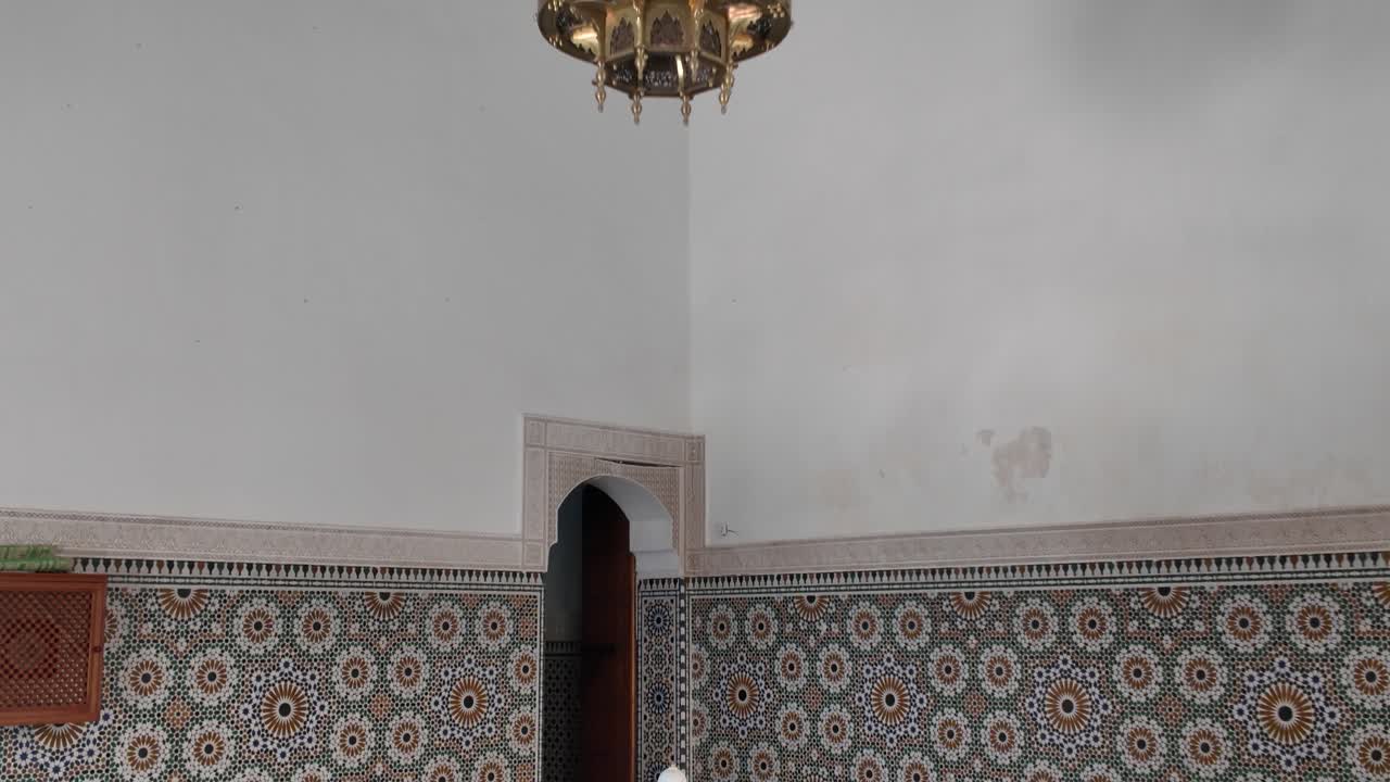 Tranquil beauty of the Mausoleum of Moulay Ismail, with ornate tilework and fountain, Meknes, Morocco