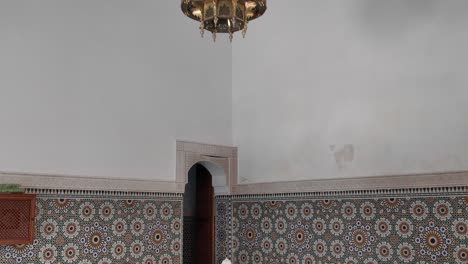 tranquil beauty of the mausoleum of moulay ismail, with ornate tilework and fountain, meknes, morocco