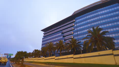 shooting-of-the-buildings-of-the-city-of-Oran-with-palm-trees-on-the-side-of-the-road-at-sunset