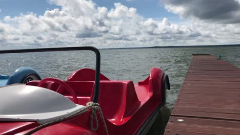 sunny weather on a freshwater lake. on the waves rock catamarans. in the blue sky lush clouds.