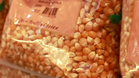 close-up video of popcorn and dal bags on a supermarket shelf, highlighting packaging details and product arrangement