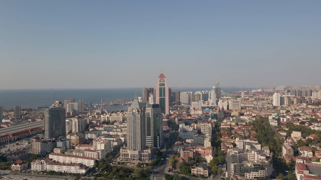 4K aerial drone footage showcasing the vibrant cityscape. This cinematic shot captures a dynamic blend of modern skyscrapers, busy roads, and classic red-tiled European-style rooftops.