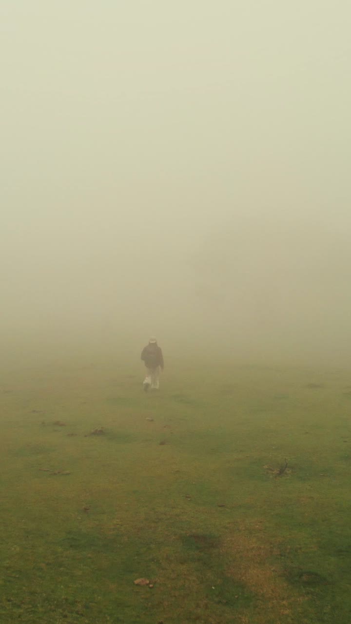 Person Hiking in Dense Fog