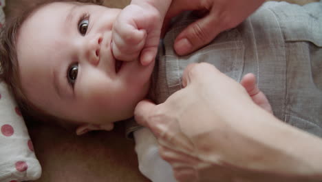 Mother-Playing-Game-With-Happy-Baby-Boy-On-Sofa-At-Home