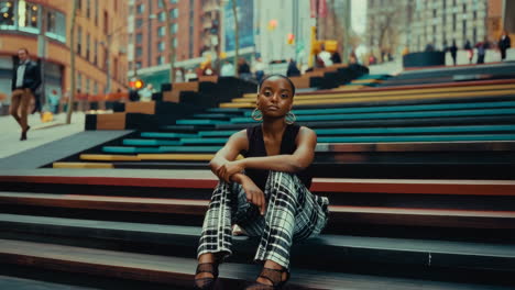 woman sitting on colorful urban stairs