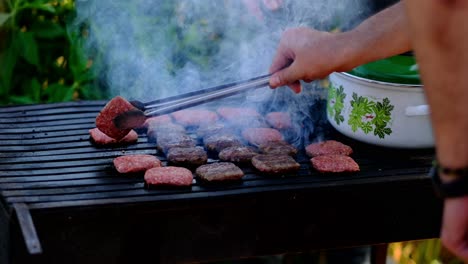 Meatballs-that-are-cooked-on-one-side-are-turned-with-tongs-slow-motion